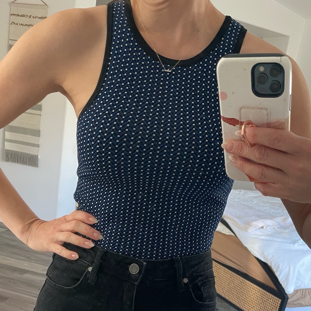 Blue knit top with black neck and arm lines and white polka dots. Size XS